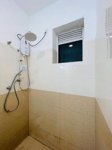 a shower in a bathroom with a window at Liyasha Villa - AEONSKY in Negombo