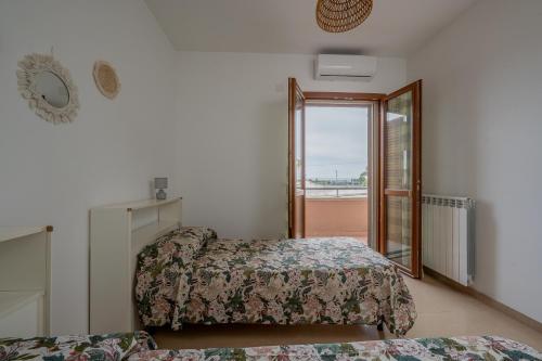 a room with two beds and a mirror and a window at ilvilLINO in Taranto