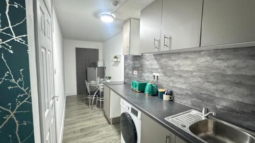 a kitchen with a sink and a counter top at Stylish Studio Flat JQ close to Villa Park & Utility Arena in Birmingham