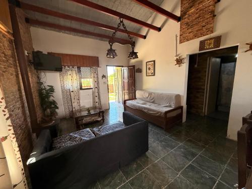 a living room with two couches and a couch at Complejo Samaya in San Clemente del Tuyú