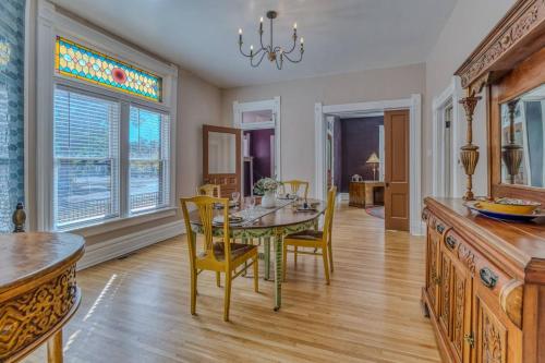 a dining room with a table and chairs at The Rosemont Estate in Florence