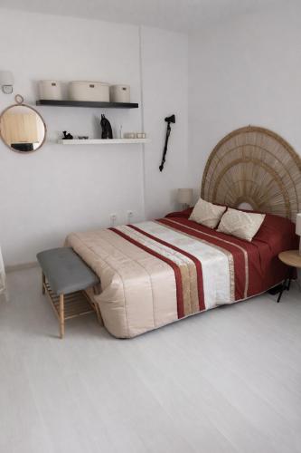 a bedroom with a large bed and a chair at Estudio Boho Mar in Praia da Rocha