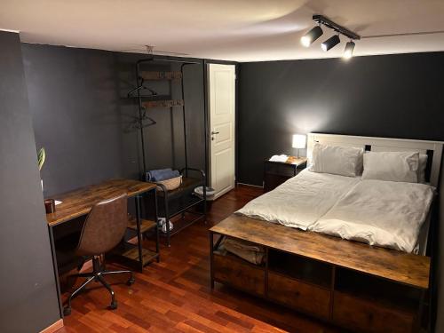 a bedroom with a bed and a desk and a desk at Large Room with Balcony -two storey condo- nearby Scandic Business Center bus stop in Stavanger