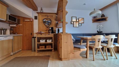 a kitchen and dining room with a table and chairs at Haus am Stein in Finkenberg
