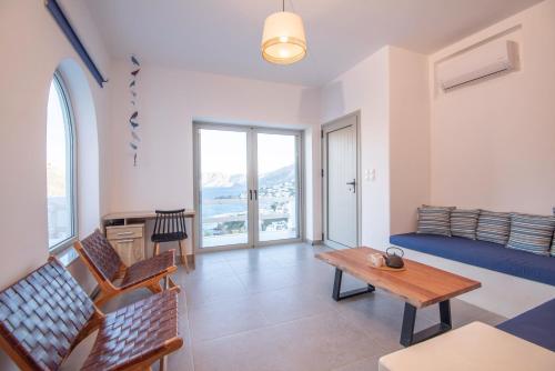a living room with a couch and a table at Casa Mare Melitsahas - Panoramic Sea View in Kalymnos