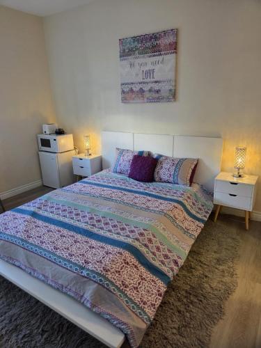 a bedroom with a large bed and two night stands at Resort Like Stay at a Cozy Relaxing Private Room Near UCI in Irvine