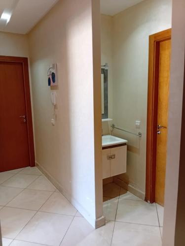 a bathroom with a sink and a mirror at Annakhil 30 in Oulad Akkou