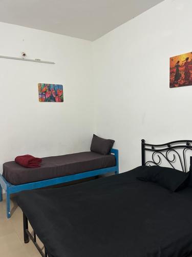 two beds sitting next to each other in a room at The Maze House Anjuna! in Anjuna