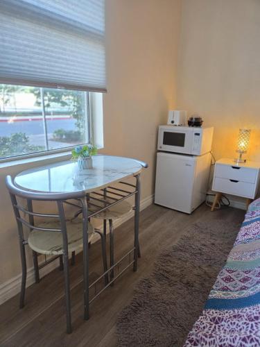 a small kitchen with a table and a microwave at Resort Like Stay at a Cozy Relaxing Private Room Near UCI in Irvine