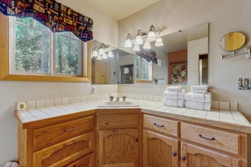 a bathroom with a sink and a mirror at Ponderosa Cabin in Bend