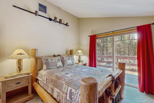 a bedroom with a bed and a large window at Ponderosa Cabin in Bend