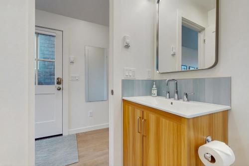 a bathroom with a sink and a mirror at Baerfoot Bungalow in Cannon Beach