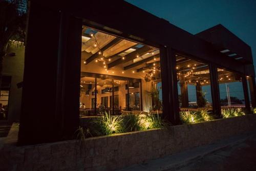 a building with windows and plants in front of it at Barrokas Inn in Piedras Negras