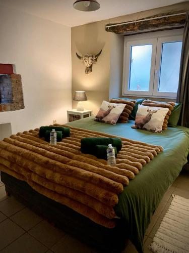a bedroom with a large bed with a large blanket at Gîte de la chapelle in Houffalize