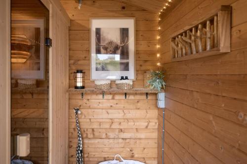 a room with wood paneling and a wall with a window at CATO Ferienhaus in Kiefersfelden