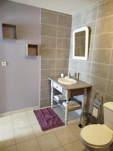 a bathroom with a sink and a toilet at L'Epinette in Torchefelon