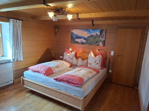 a bedroom with a bed with two pillows on it at Ferienwohnung Faschinggut in Rottau