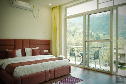 a bedroom with a bed and a large window at The Oaks - Scenic Couple Retreat in Kasauli with Private Balcony Views in Kasauli