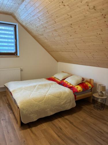 a bedroom with a large bed in a attic at Chata v Oščadnici - Slniečko in Čadca