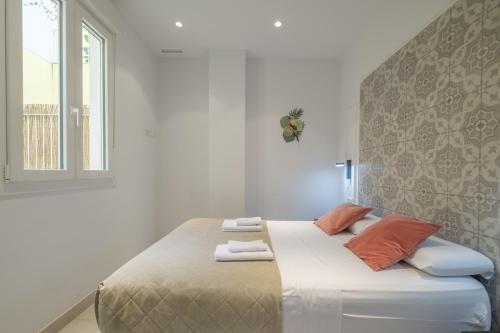 a large bed in a white room with a window at Chic & Comfortable Apartment, Private Terrace in Valencia