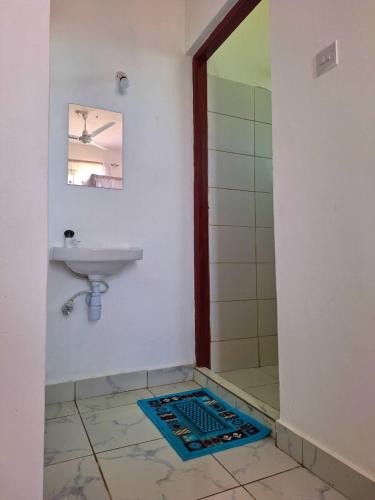 a bathroom with a sink and a shower at Adventure studio apartment in Mtwapa