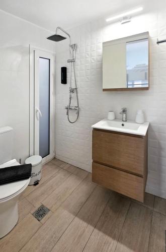 a bathroom with a toilet and a sink and a shower at KYMO Private Seafront Residence in Koutsourás