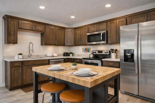 a kitchen with wooden cabinets and stainless steel appliances at Mountain View Haven in Belgrade in Belgrade