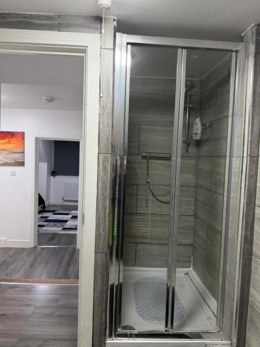 a glass shower in a bathroom with a room at Bpsairbnbltd in London