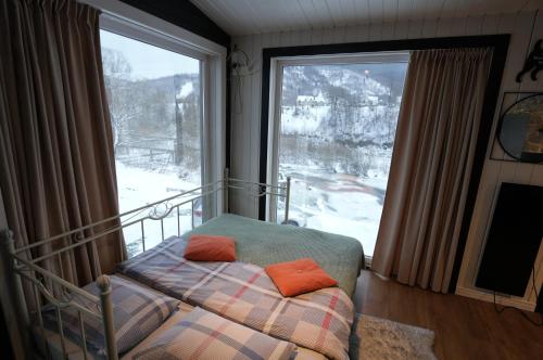 a bedroom with a bed in front of a large window at Креси in Yaremche