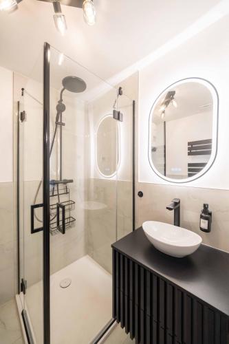 a bathroom with a sink and a shower at NORDÉA Apartments in Rostock