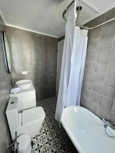 a bathroom with a toilet and a sink and a shower at Casa da Avó Elvina in Angra do Heroísmo