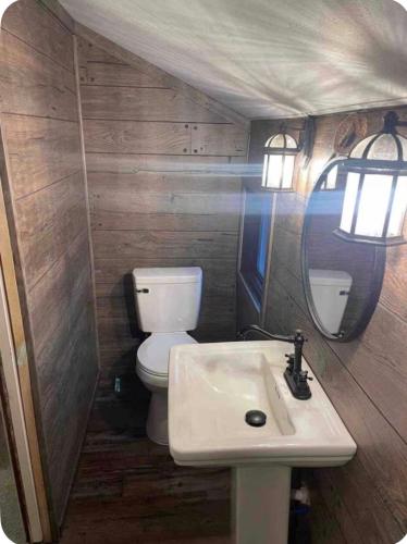 a small bathroom with a toilet and a sink at The Hideaway in North Canton