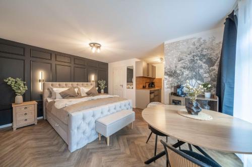 a bedroom with a bed and a table and a dining room at NORDÉA Apartments in Rostock