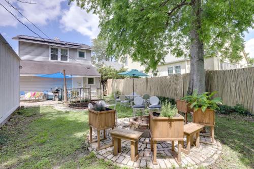 a backyard with tables and chairs and a fence at 2 Mi to LSU Mid City Home with Yard and Patio! in Baton Rouge