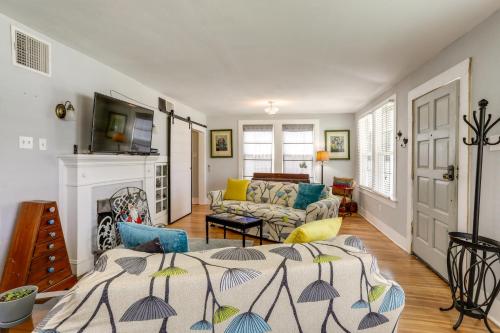 a living room with a bed and a fireplace at 2 Mi to LSU Mid City Home with Yard and Patio! in Baton Rouge