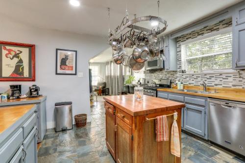 a kitchen with a wooden island in the middle at 2 Mi to LSU Mid City Home with Yard and Patio! in Baton Rouge