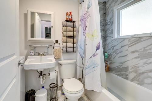 a bathroom with a toilet and a sink and a shower at 2 Mi to LSU Mid City Home with Yard and Patio! in Baton Rouge