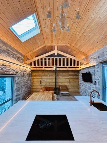 a living room with a ceiling with a skylight at Neds Barn in Galway