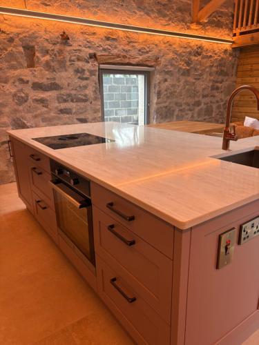 a kitchen with a counter top and a sink at Neds Barn in Galway