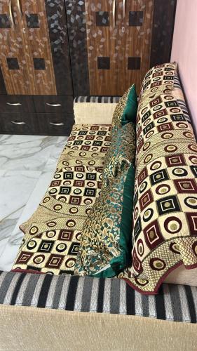 a bed with four pillows on top of it at Apartment in Khardaha in Khardah