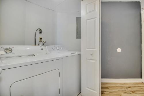 a white kitchen with a sink and a washing machine at Oceanfront Suite, Seascape Sanctuary at OceanPark! 1104 in Myrtle Beach