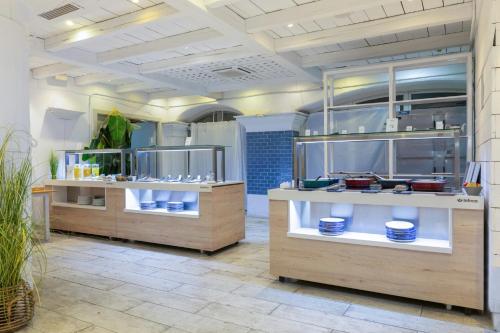 a kitchen with counters with dishes on display at Sercotel Kalma Sitges in Sitges