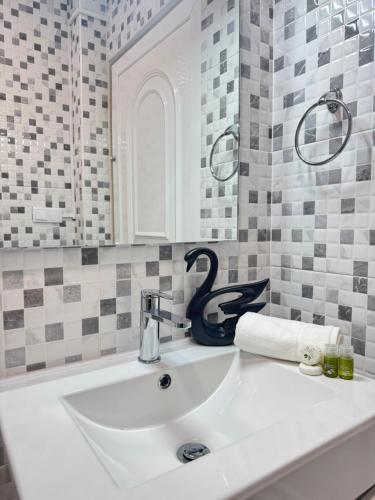 a white sink in a bathroom with a mirror at Villa Bonita Guesthouse Albufeira Old Town in Albufeira