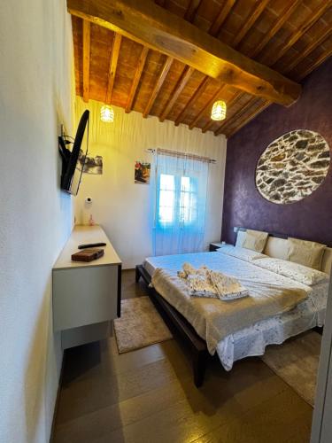a bedroom with a bed and a desk in it at La Casa di Thor in Porto Azzurro
