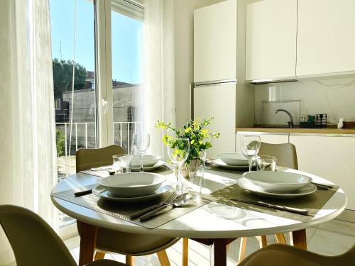 a dining room table with plates and glasses on it at Corso 42 in Novara