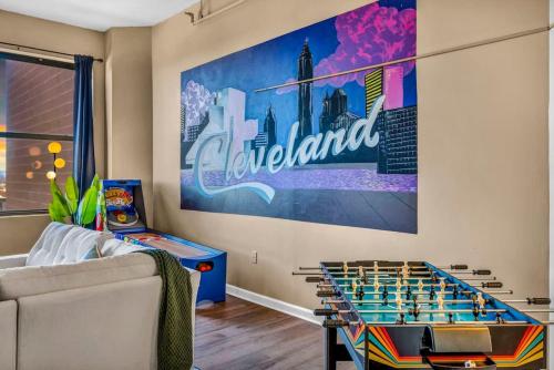 a living room with a giant chess board on the wall at Fun 2Bed Apt Skeeball Foosball FREE Parking in Cleveland