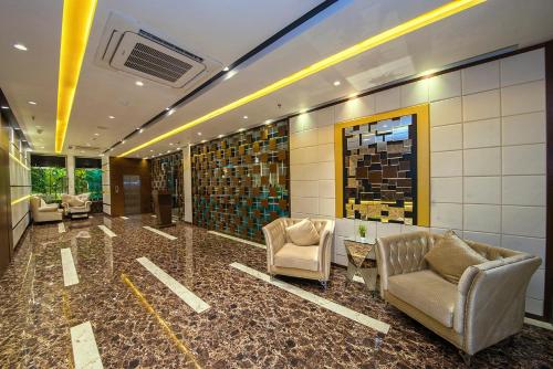a lobby with couches and chairs in a building at The Fern Residency Kolkata in Kolkata