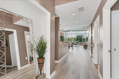 a hallway of a home with a potted plant at Spacious Apartment Masterfully Decorated in Orlando