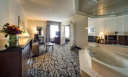 a hotel room with a bathroom with a tub at Monte Carlo Inn Oakville Suites in Oakville
