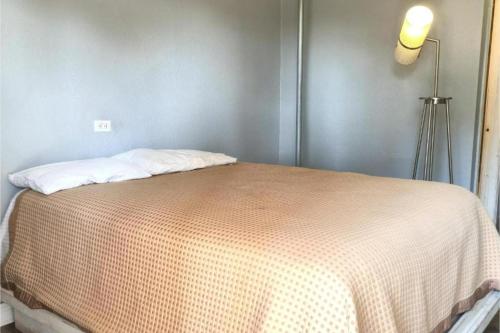 a bed in a room with a lamp next to it at Mi Amor Inn & Suites by Hotel O Dallas Tx Hwy 352 in Dallas